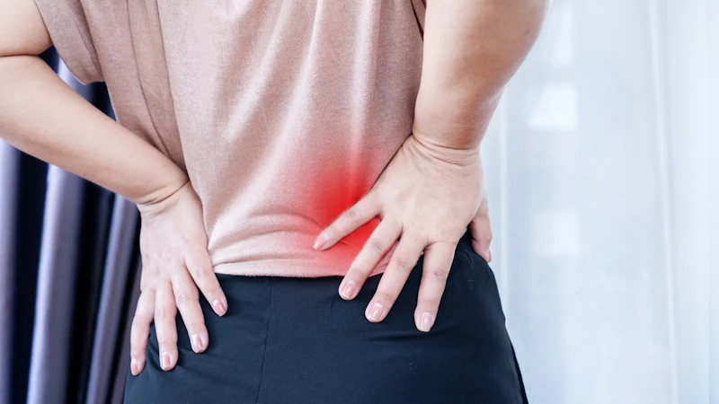 A woman suffering back pain from degenerative disc disease